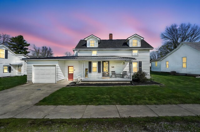 28 Elm St, Kingston, OH 45644 - view of front of home featuring driveway, covered porch, a chimney, a lawn, and a garage