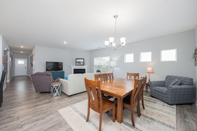 458 Madison Way, Plain City, OH 43064 - dining area featuring a chandelier, a fireplace, baseboards, light wood-style floors, and recessed lighting