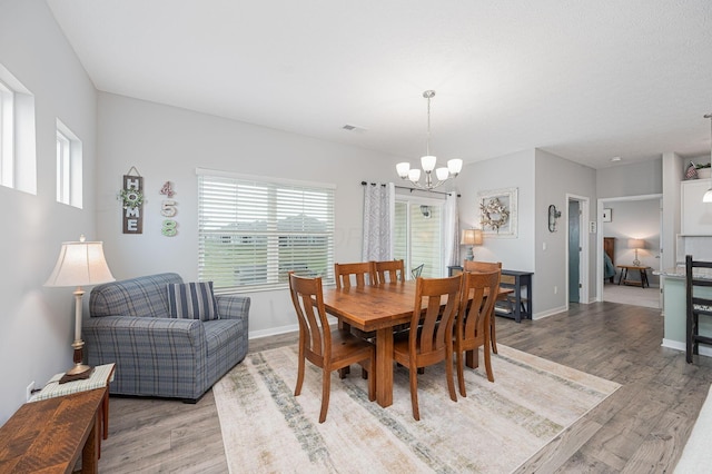 458 Madison Way, Plain City, OH 43064 - dining space featuring baseboards, visible vents, light wood-type flooring, and a notable chandelier
