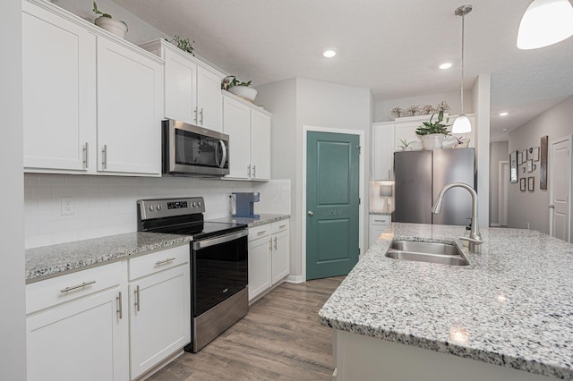 458 Madison Way, Plain City, OH 43064 - kitchen with a sink, tasteful backsplash, appliances with stainless steel finishes, white cabinets, and light wood-style floors