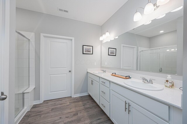 458 Madison Way, Plain City, OH 43064 - full bathroom with wood finished floors, a sink, a stall shower, and visible vents