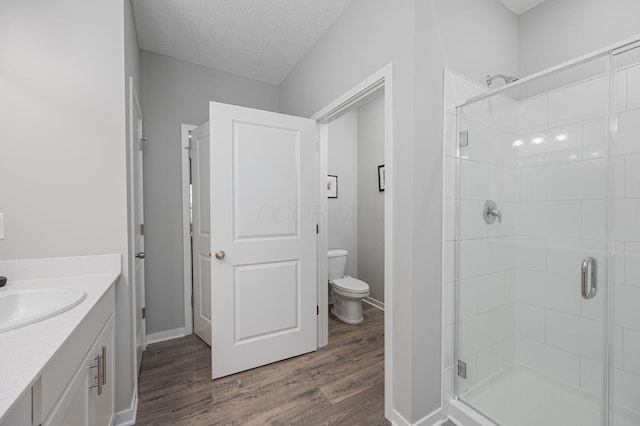 458 Madison Way, Plain City, OH 43064 - bathroom with a textured ceiling, wood finished floors, a stall shower, and toilet