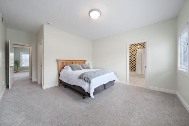 bedroom featuring baseboards and light colored carpet