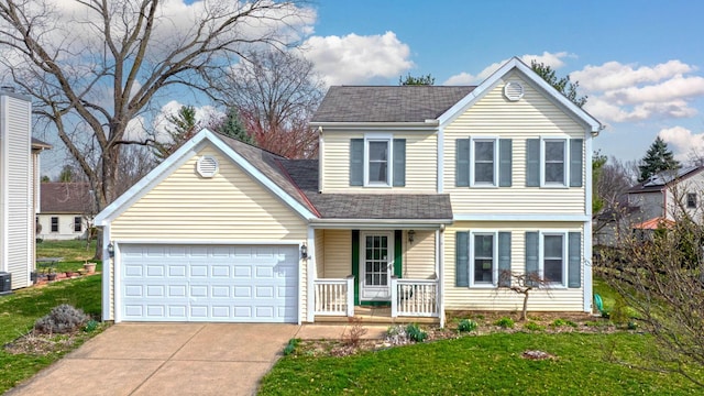 traditional-style home with covered porch, concrete driveway, an attached garage, a front lawn, and a shingled roof