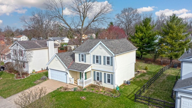 view of front facade featuring fence, a garage, a front yard, roof with shingles, and driveway