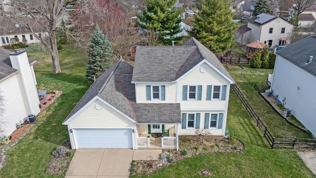 view of front facade featuring an attached garage, a shingled roof, fence, and concrete driveway
