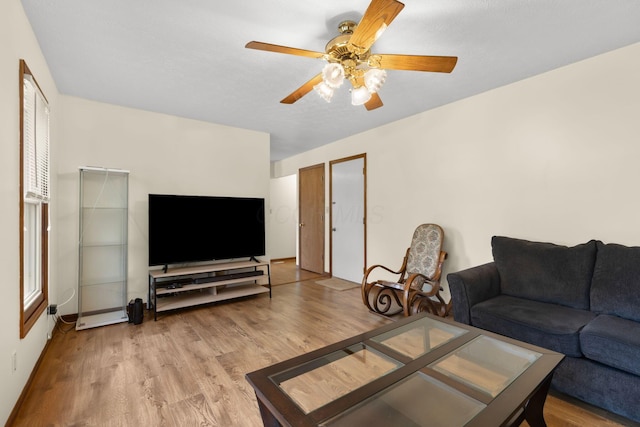 living room featuring ceiling fan and wood finished floors