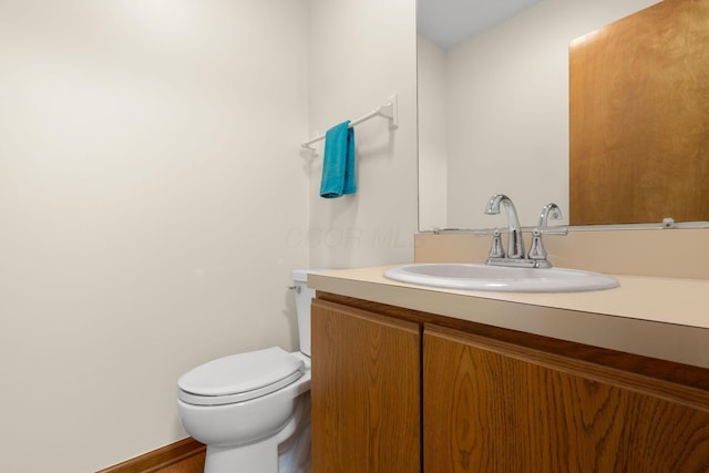 bathroom featuring toilet and vanity