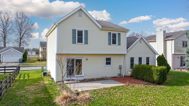 rear view of house featuring fence, a yard, and a patio area