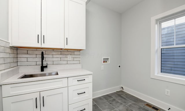 166 Miami Ave, Columbus, OH 43203 - laundry room featuring washer hookup, cabinet space, and electric dryer hookup