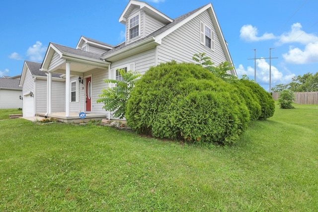 335 Mae St, Logan, OH 43138 - view of front facade featuring a garage, covered porch, and a front yard