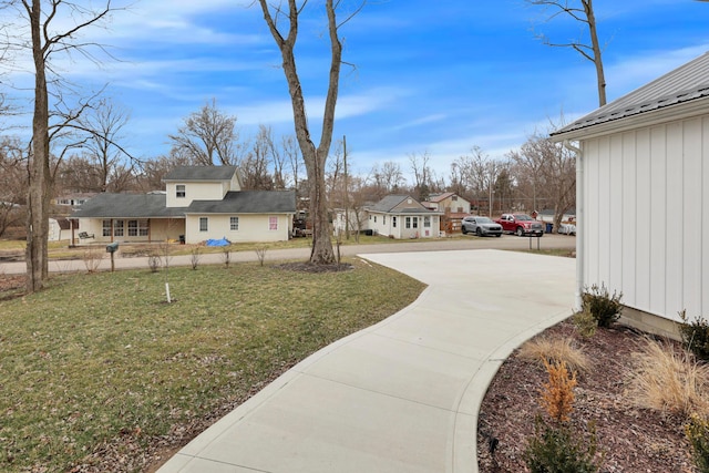13334 Pine Rd NE, Thornville, OH 43076 - view of grassy yard featuring concrete driveway and a residential view