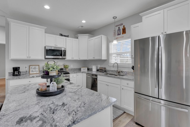 13334 Pine Rd NE, Thornville, OH 43076 - kitchen featuring stainless steel appliances, recessed lighting, white cabinets, light wood-style flooring, and light stone counters