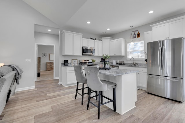 13334 Pine Rd NE, Thornville, OH 43076 - kitchen featuring appliances with stainless steel finishes, a breakfast bar area, white cabinets, recessed lighting, and a kitchen island