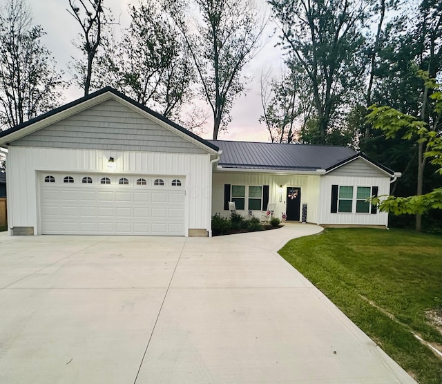 13334 Pine Rd NE, Thornville, OH 43076 - ranch-style home with board and batten siding, an attached garage, concrete driveway, and a front yard