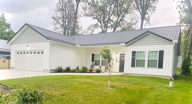 13334 Pine Rd NE, Thornville, OH 43076 - view of front of property with a garage, a metal roof, a front yard, a standing seam roof, and driveway