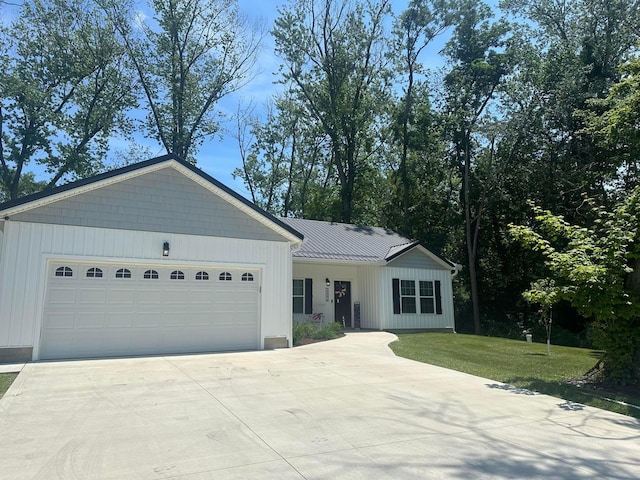 13334 Pine Rd NE, Thornville, OH 43076 - ranch-style home with driveway, a garage, a front yard, and a metal roof