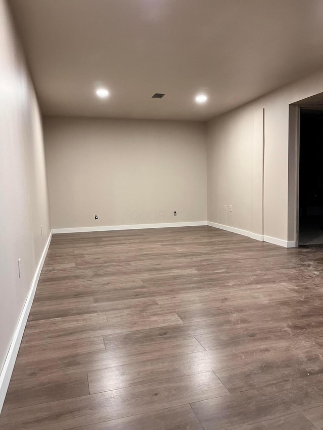 below grade area featuring wood finished floors, recessed lighting, and baseboards