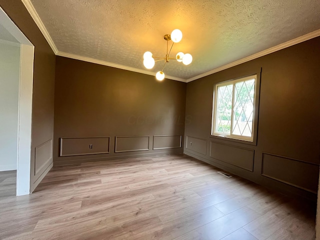 11795 Huntington Way NW, Pickerington, OH 43147 - unfurnished room featuring a decorative wall, light wood-style floors, a chandelier, a textured ceiling, and ornamental molding
