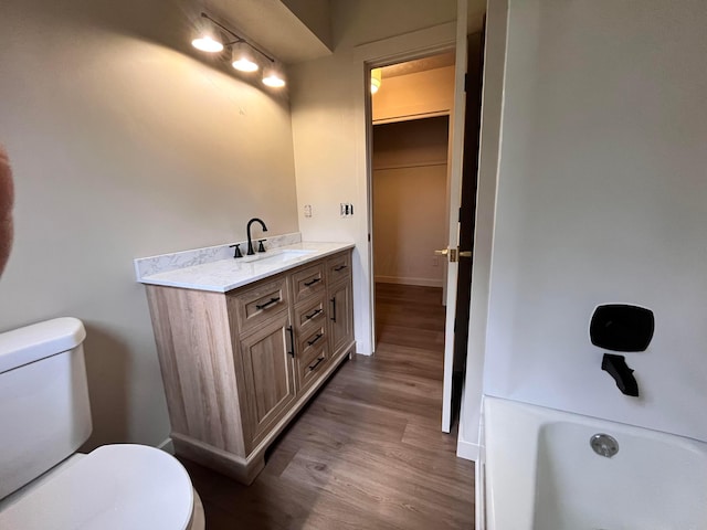 11795 Huntington Way NW, Pickerington, OH 43147 - full bath featuring toilet, wood finished floors, a tub to relax in, baseboards, and vanity