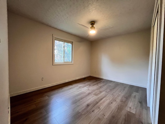 11795 Huntington Way NW, Pickerington, OH 43147 - spare room with dark wood-style flooring, a ceiling fan, a textured ceiling, and baseboards