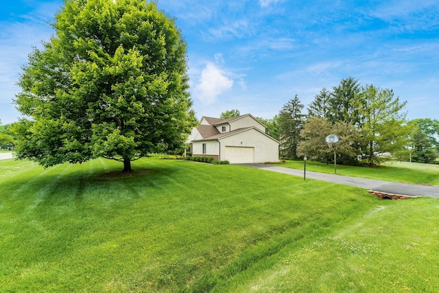 11795 Huntington Way NW, Pickerington, OH 43147 - obstructed view of property featuring asphalt driveway, a front lawn, and stucco siding