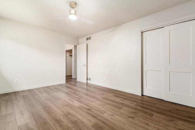 11795 Huntington Way NW, Pickerington, OH 43147 - unfurnished bedroom featuring wood finished floors, a closet, and a ceiling fan