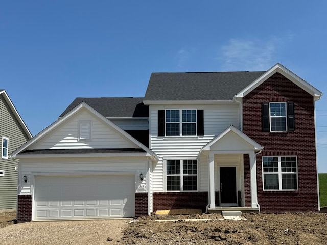 view of front facade with dirt driveway, brick siding, and a garage