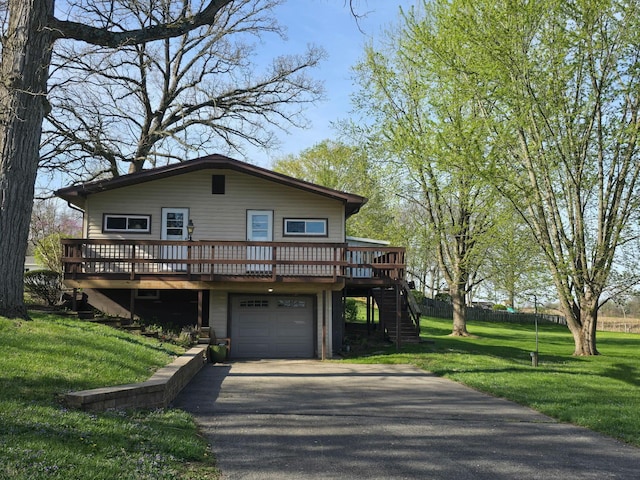 view of front of home with stairway, an attached garage, a wooden deck, driveway, and a front yard