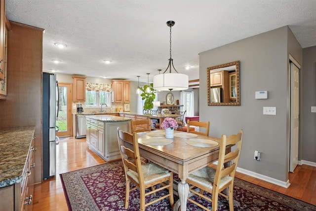 397 E Schrock Rd, Westerville, OH 43081 - dining space featuring light wood-style flooring, baseboards, and a textured ceiling