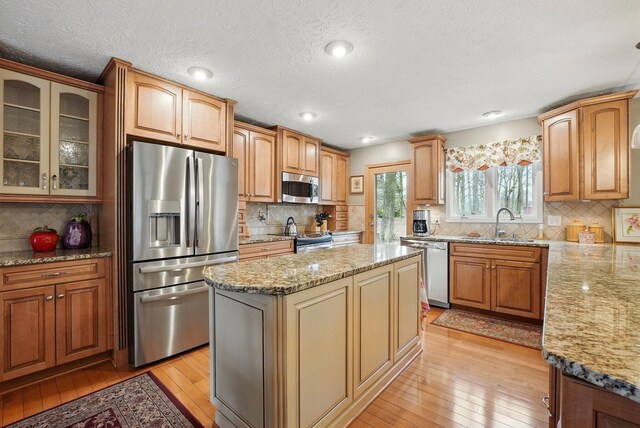 397 E Schrock Rd, Westerville, OH 43081 - kitchen with a sink, stainless steel appliances, light stone countertops, and light wood-type flooring
