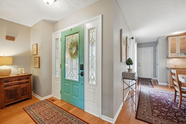 397 E Schrock Rd, Westerville, OH 43081 - entryway with light wood-style flooring, visible vents, baseboards, and a textured ceiling