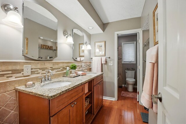 397 E Schrock Rd, Westerville, OH 43081 - bathroom featuring double vanity, toilet, a sink, and hardwood / wood-style floors