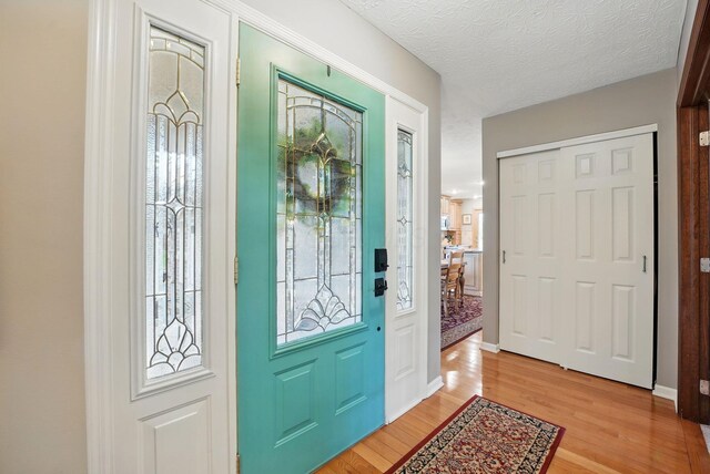 397 E Schrock Rd, Westerville, OH 43081 - entryway with light wood finished floors, baseboards, and a textured ceiling