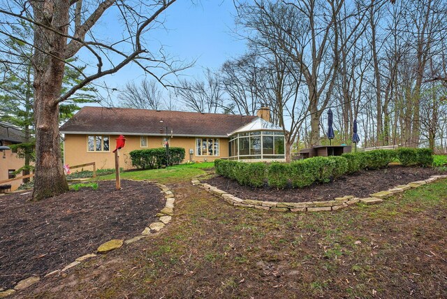 397 E Schrock Rd, Westerville, OH 43081 - back of house with stucco siding, a sunroom, and a chimney