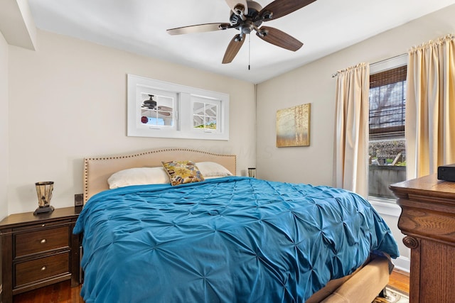 bedroom with ceiling fan and dark wood-type flooring