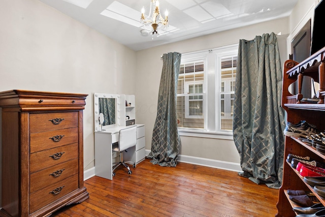 office space with hardwood / wood-style flooring, a notable chandelier, and baseboards