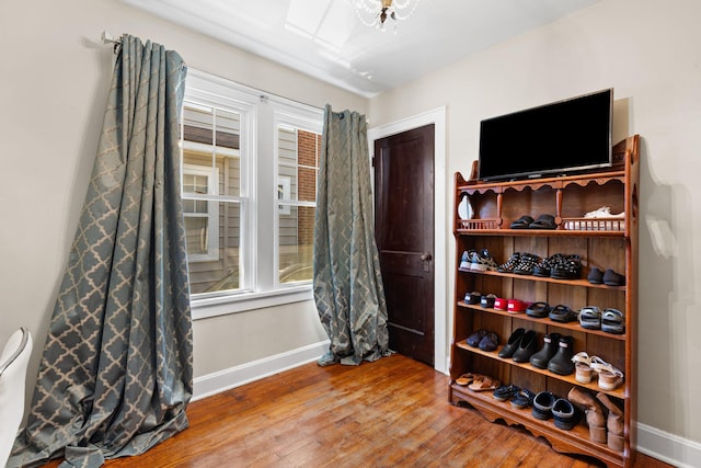 interior space featuring wood finished floors and baseboards