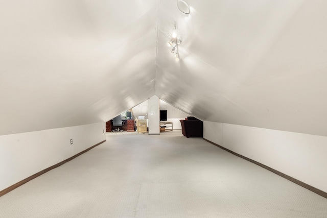 bonus room with vaulted ceiling, carpet floors, and baseboards