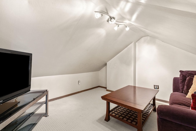 living room featuring vaulted ceiling, carpet floors, and baseboards