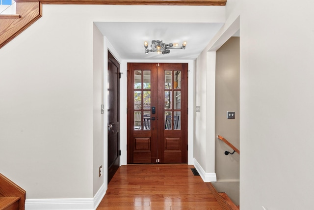 foyer entrance with baseboards and light wood-type flooring