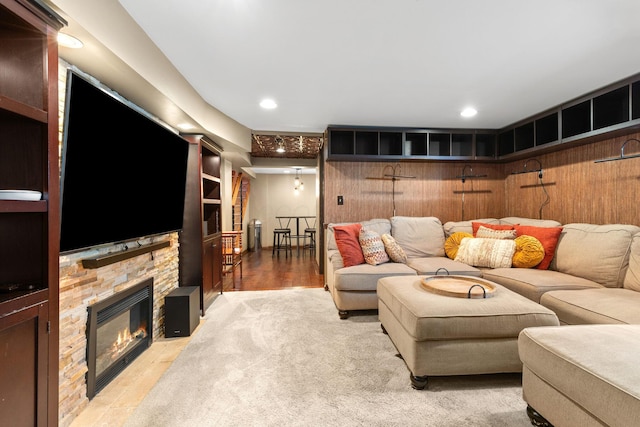living room featuring a stone fireplace and recessed lighting