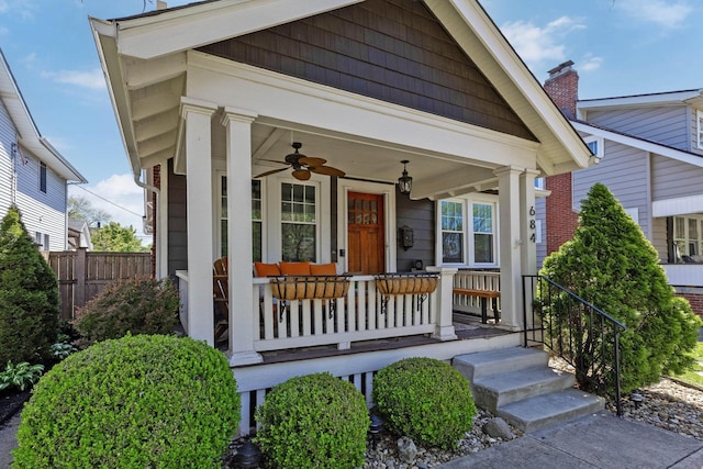 view of front of property with a ceiling fan, covered porch, and fence
