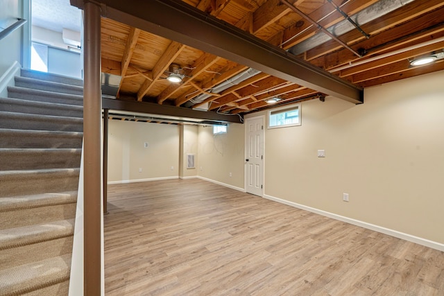 488 Springwood Lake Dr, Columbus, OH 43230 - below grade area featuring stairs, wood finished floors, and baseboards