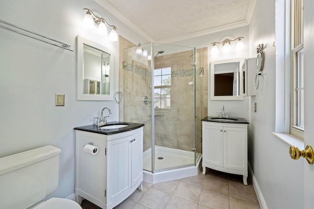 488 Springwood Lake Dr, Columbus, OH 43230 - bathroom featuring a shower stall, crown molding, toilet, two vanities, and tile patterned floors