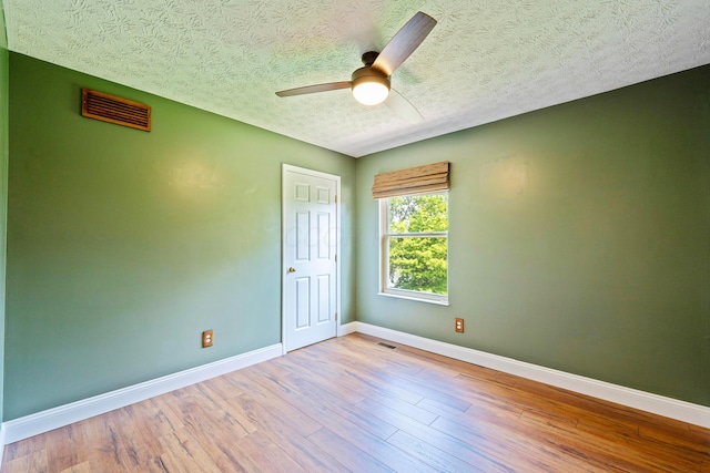 488 Springwood Lake Dr, Columbus, OH 43230 - unfurnished room with a textured ceiling, baseboards, wood finished floors, and ceiling fan