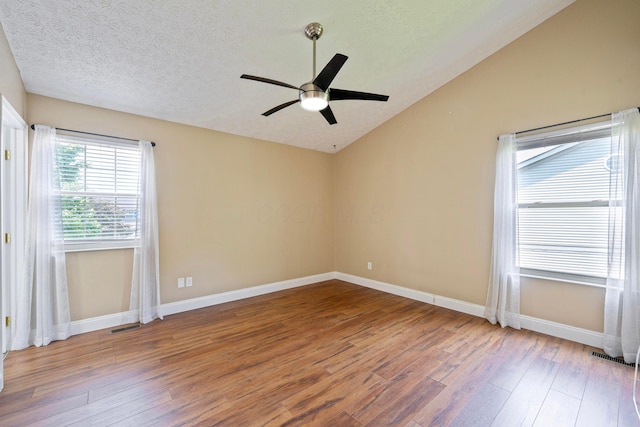 488 Springwood Lake Dr, Columbus, OH 43230 - empty room with wood finished floors, lofted ceiling, a ceiling fan, baseboards, and a textured ceiling