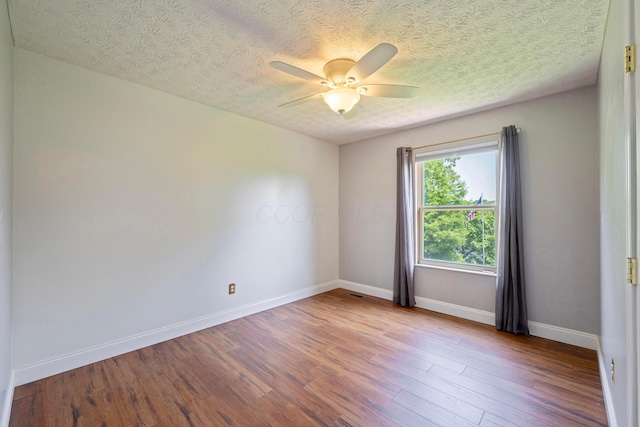 488 Springwood Lake Dr, Columbus, OH 43230 - unfurnished room with wood finished floors, ceiling fan, a textured ceiling, and baseboards