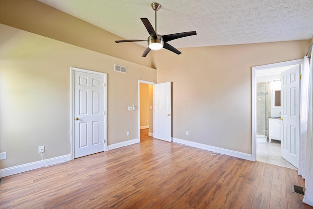 488 Springwood Lake Dr, Columbus, OH 43230 - unfurnished bedroom featuring wood finished floors, baseboards, vaulted ceiling, a textured ceiling, and ceiling fan