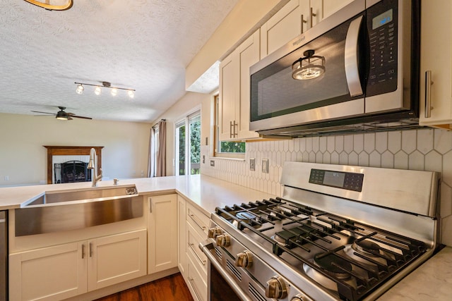 488 Springwood Lake Dr, Columbus, OH 43230 - kitchen with appliances with stainless steel finishes, a sink, light countertops, ceiling fan, and a textured ceiling